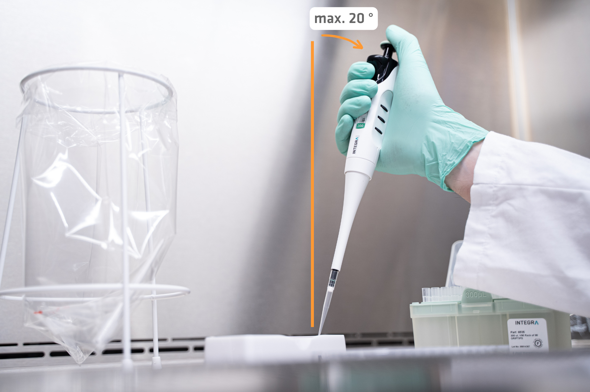 Scientist holding a pipette at an angle of about 20 degrees
