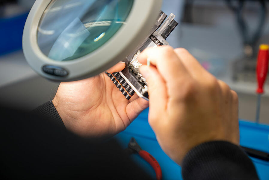A technician from INTEGRA checking a Pippeten head.