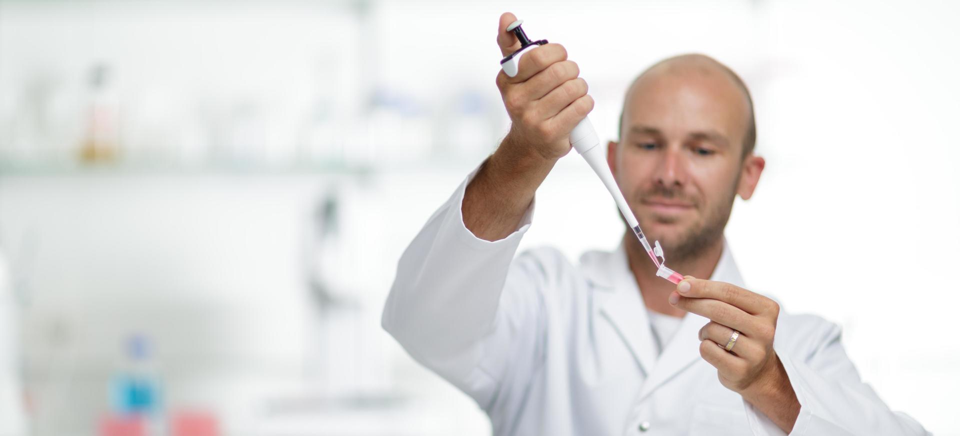 Scientist using an EVOLVE manual single channel pipette to dispense into an Eppendorf tube.
