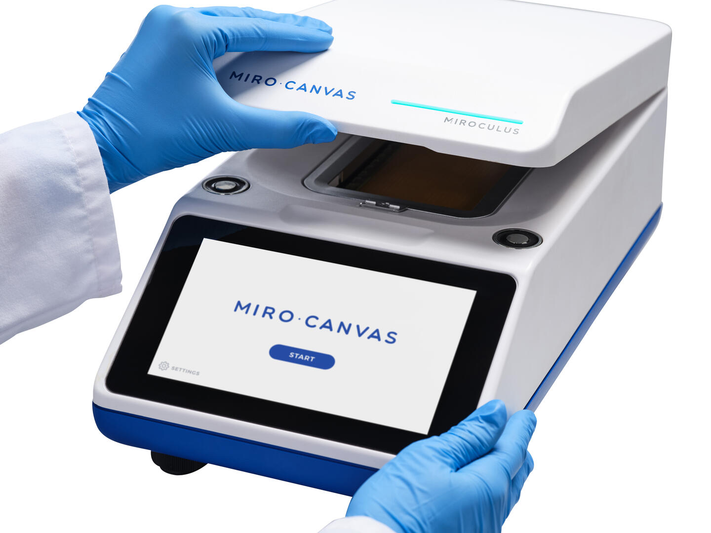 Scientist opening the lid of a MIRO CANVAS digital microfluidics platform