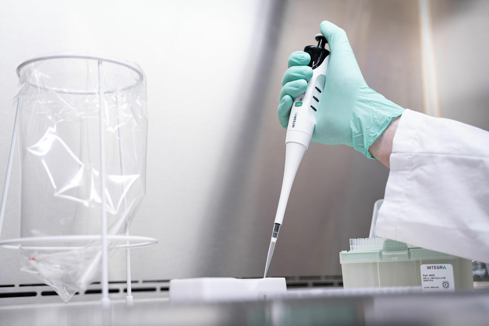 Scientist pipetting with a single channel manual EVOLVE pipette