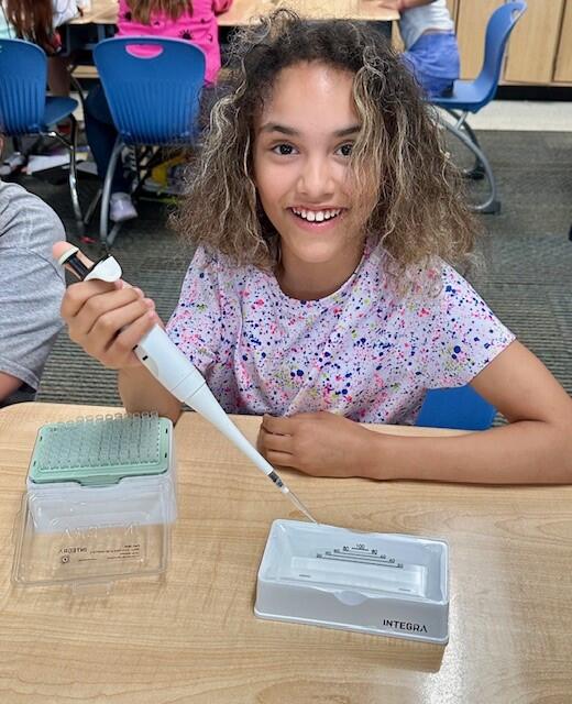 Student of an Ohio elementary school with an EVOLVE pipette