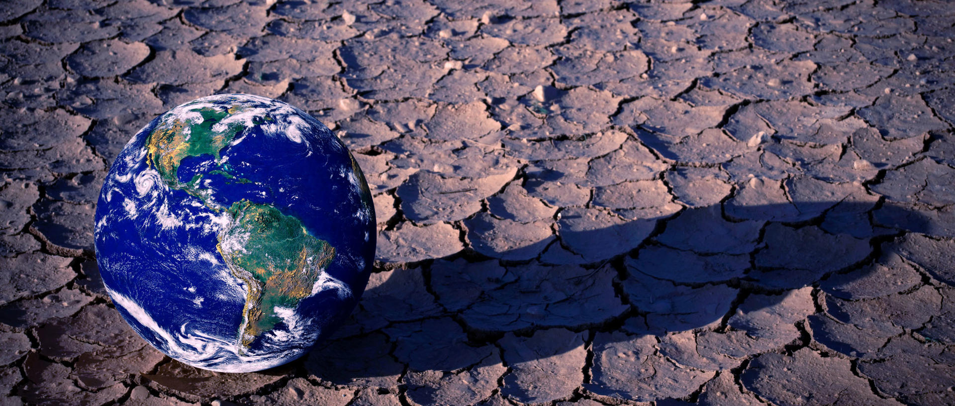 Green shift: planet earth on dry soil