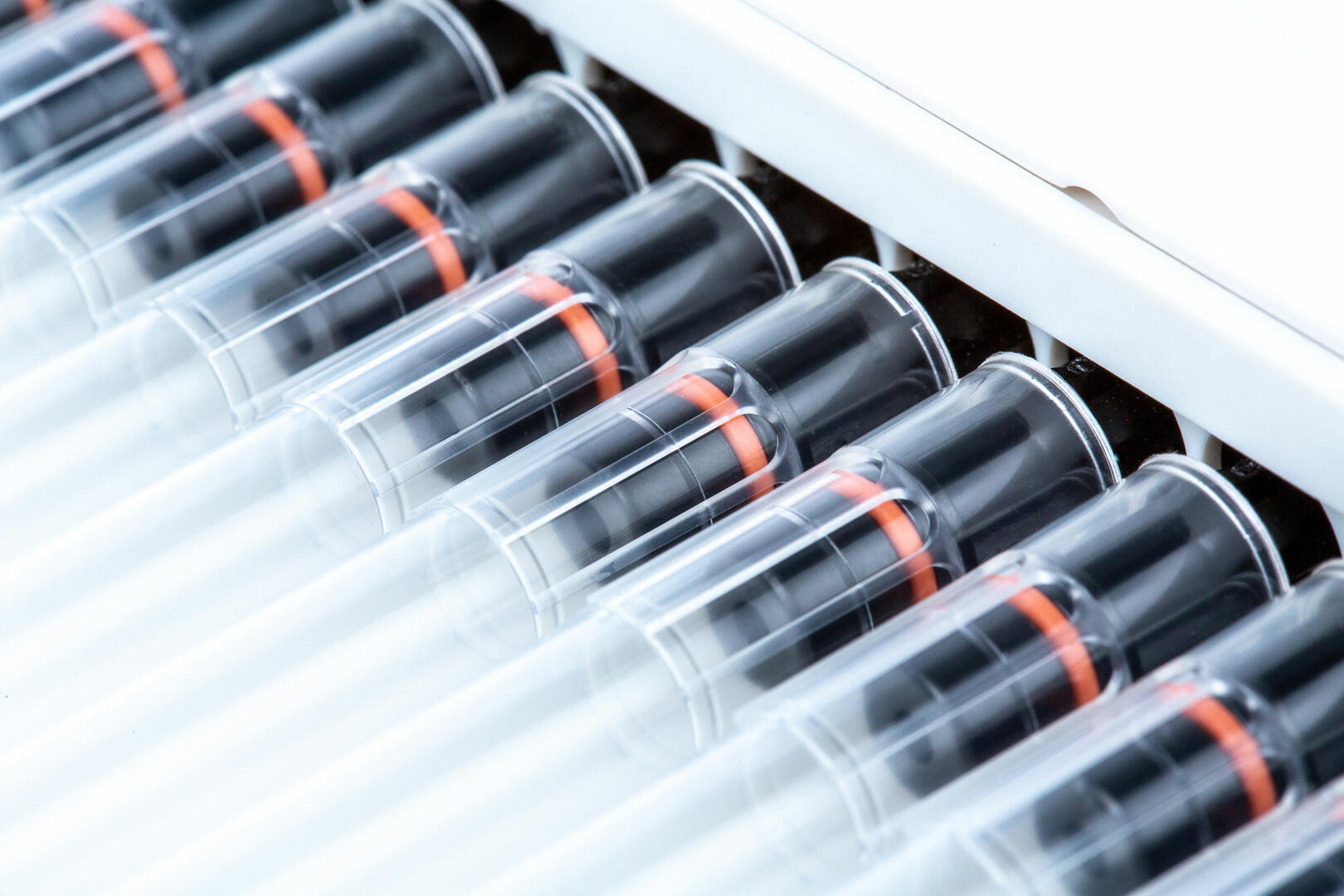 Closeup of a multichannel pipette with pipette tips attached to the fittings