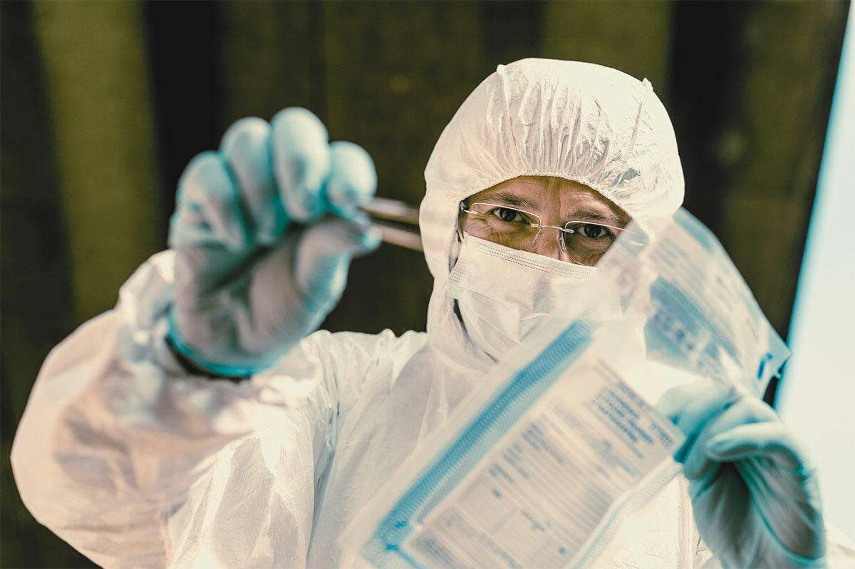 Scientist collecting a forensic sample from a crime scene