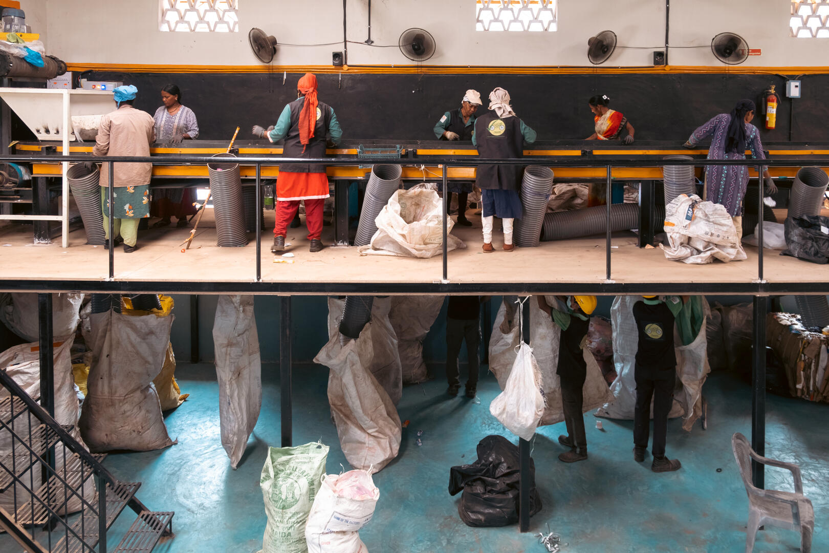 CleanHub employees processing plastic waste at a sorting center