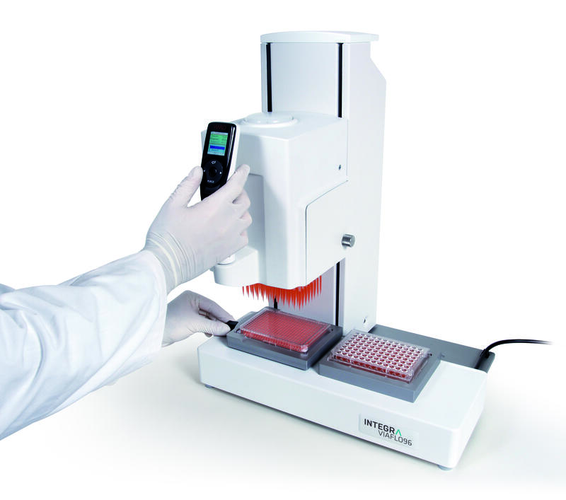 Scientist using a VIAFLO 384 channel pipette to reformat 96 well plates into a 384 well plate