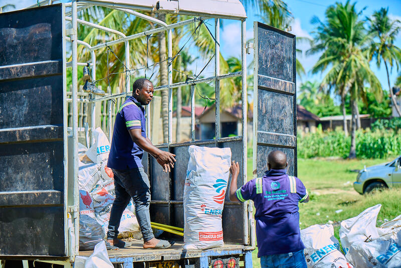 CleanHub employees unloading plastic waste from a truck.