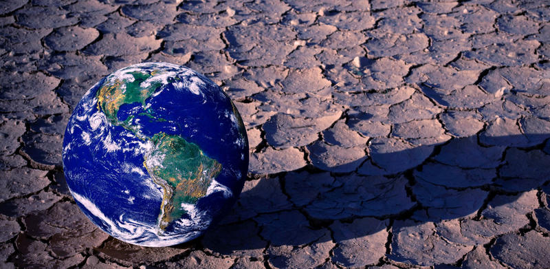 Green shift: planet earth on dry soil