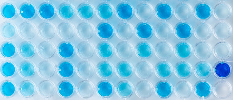 Each well of the 96 well plate has a different shade of blue because it was used to perform an ELISA test