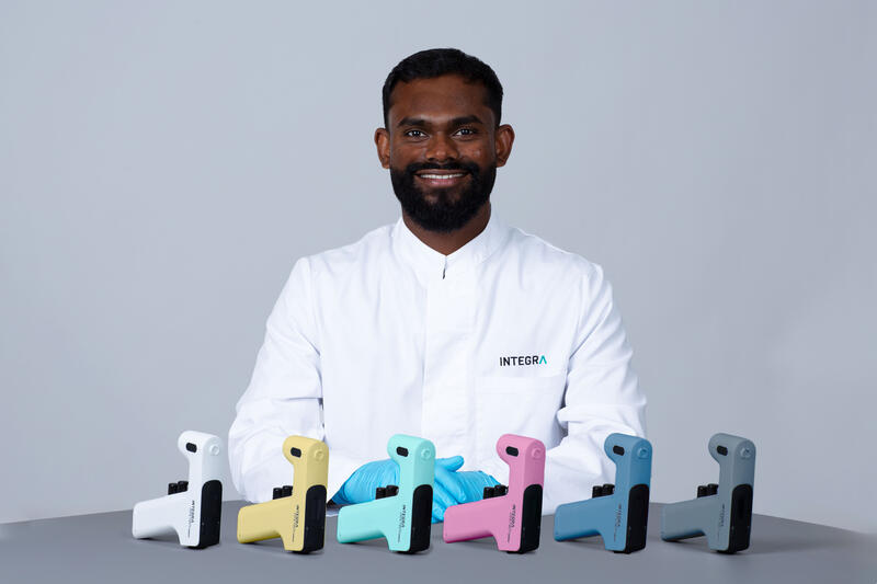 PIPETBOY GENIUS in all six colors in front of an INTEGRA employee
