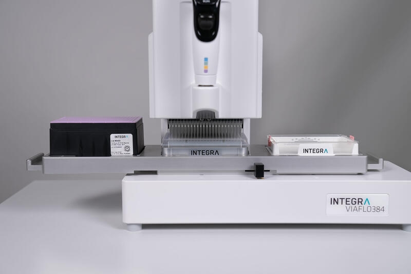 A close-up of the VIAFLO 384 handheld electronic pipette pooling together cDNA samples in a reservoir.