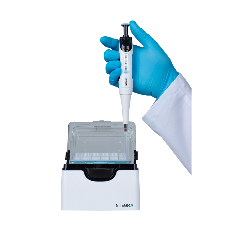 Scientist loading a pipette tip from a PopTop Base with a single channel EVOLVE pipette