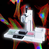 The ASSIST PLUS pipetting robot with immunofluorescent staining of fibroblasts in the background.